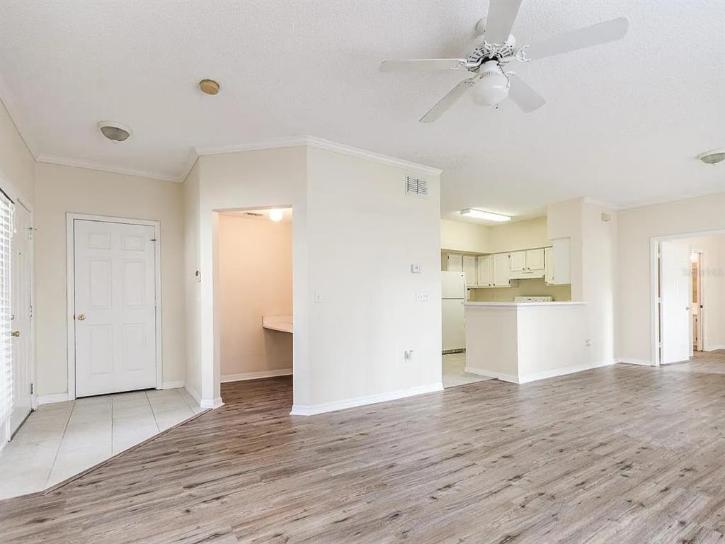 10000 Southwest 52nd Avenue, Unit 99 Gainesville, FL 32608 - Photo 5 of 19 a view of a kitchen with wooden floor and a kitchen space