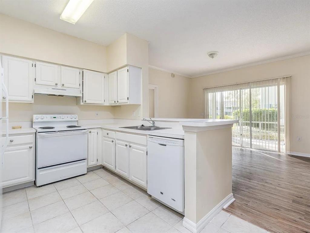 10000 Southwest 52nd Avenue, Unit 99 Gainesville, FL 32608 - Photo 6 of 19 a kitchen with cabinets appliances and a large window