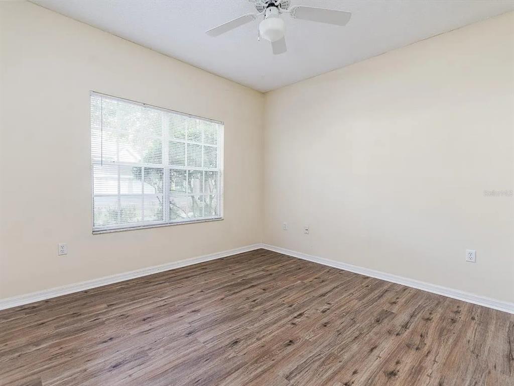 10000 Southwest 52nd Avenue, Unit 99 Gainesville, FL 32608 - Photo 9 of 19 wooden floor in an empty room with a window