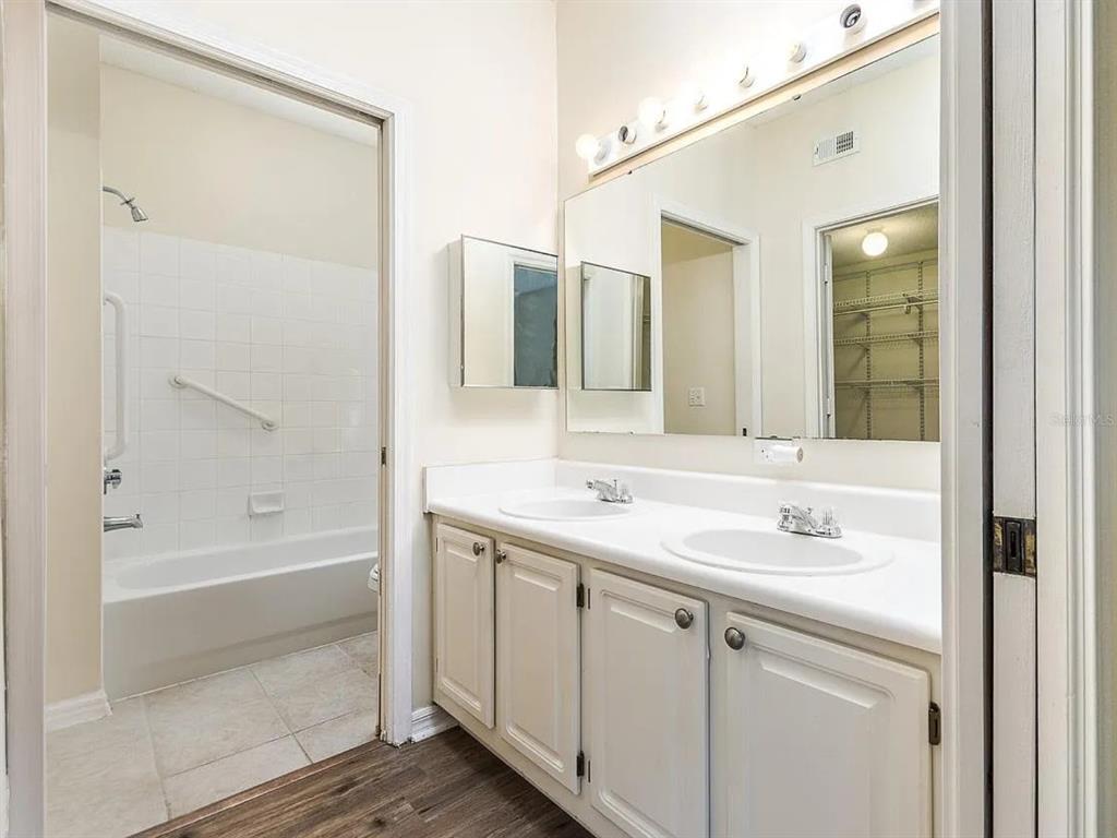 10000 Southwest 52nd Avenue, Unit 99 Gainesville, FL 32608 - Photo 10 of 19 a bathroom with a tub sink and mirror