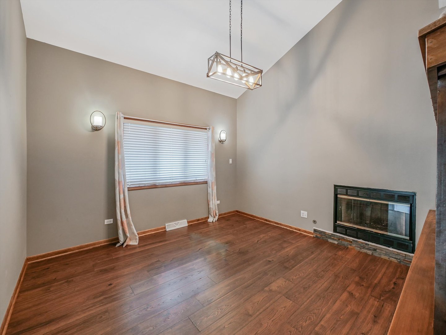 7240 West Colleen Court Monee, IL 60449 - Photo 11 of 57 a view of empty room with wooden floor and fireplace