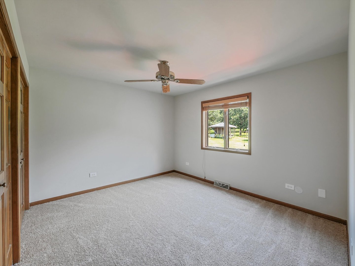 7240 West Colleen Court Monee, IL 60449 - Photo 22 of 57 an empty room with windows and chandelier fan