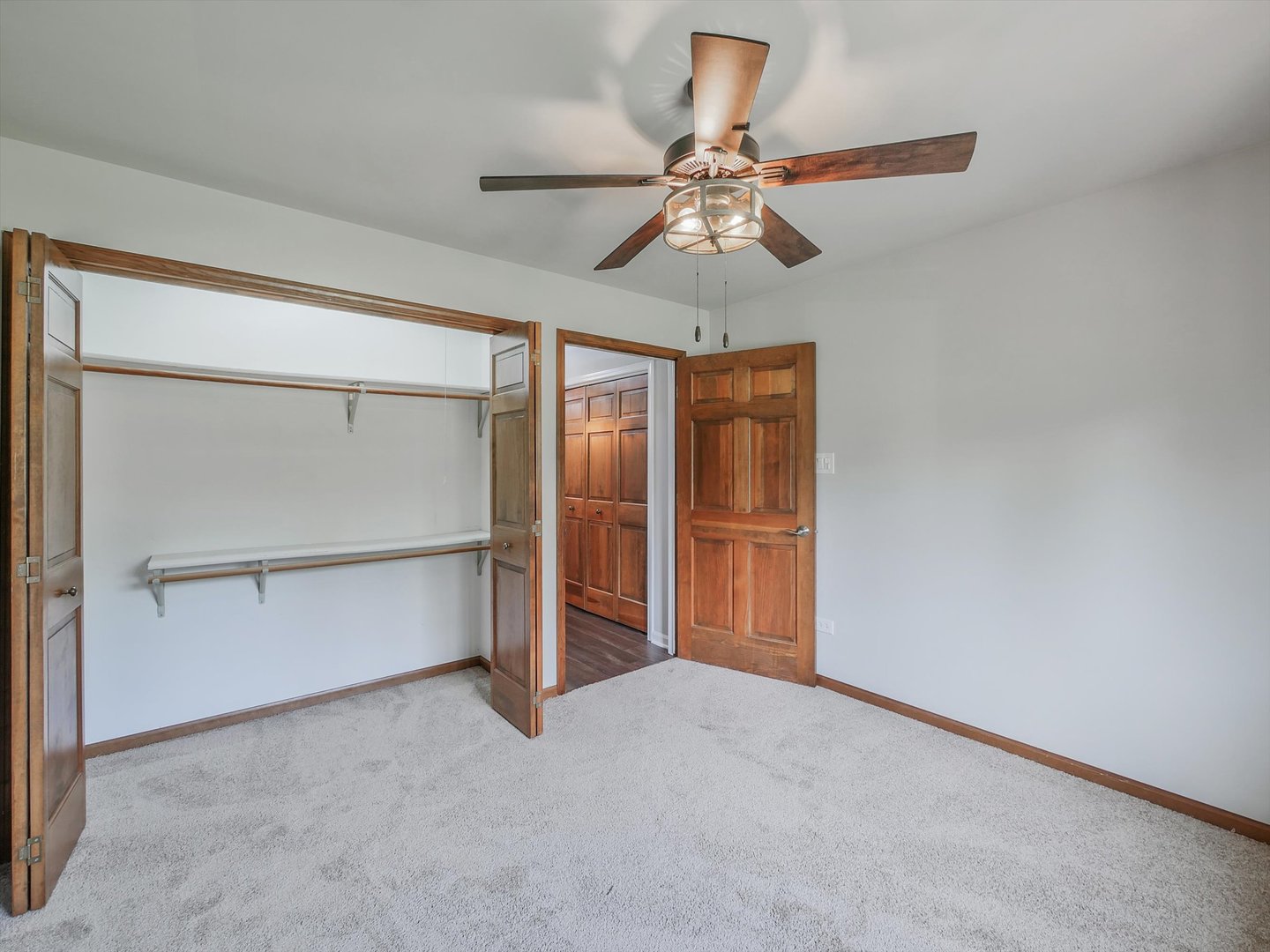 7240 West Colleen Court Monee, IL 60449 - Photo 27 of 57 an empty room with closet and a chandelier fan
