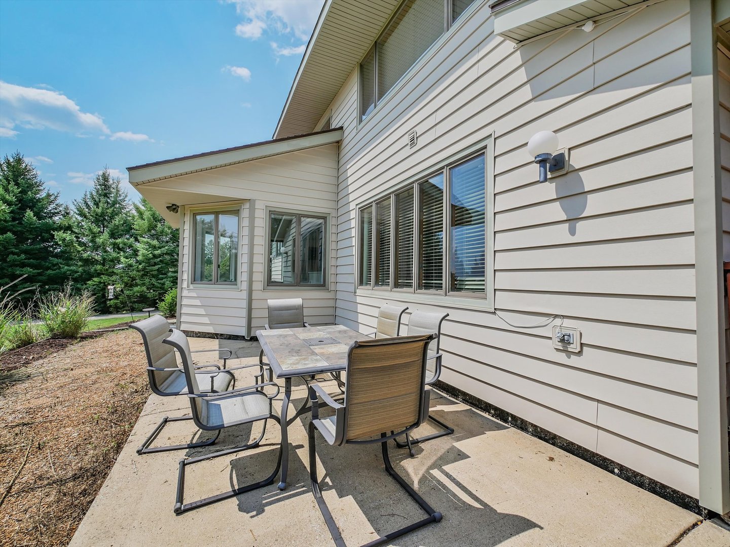 7240 West Colleen Court Monee, IL 60449 - Photo 45 of 57 a view of a patio with table and chairs and wooden floor