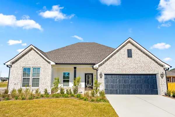 a front view of house with yard outdoor seating and barbeque oven