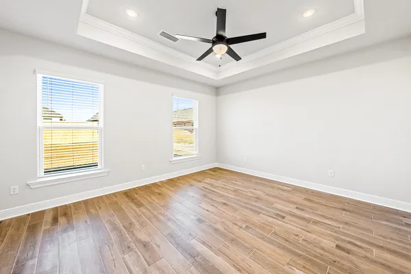 a view of empty room with wooden floor
