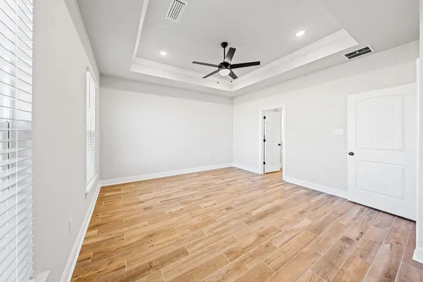 a spacious bathroom with a sink and mirror
