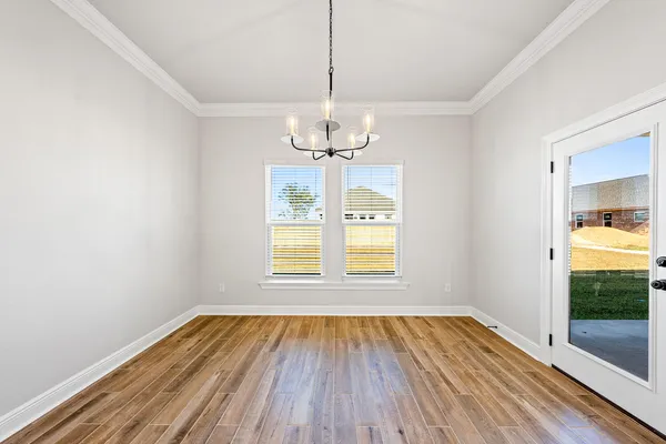 a large kitchen with stainless steel appliances lots of counter space and wooden floor