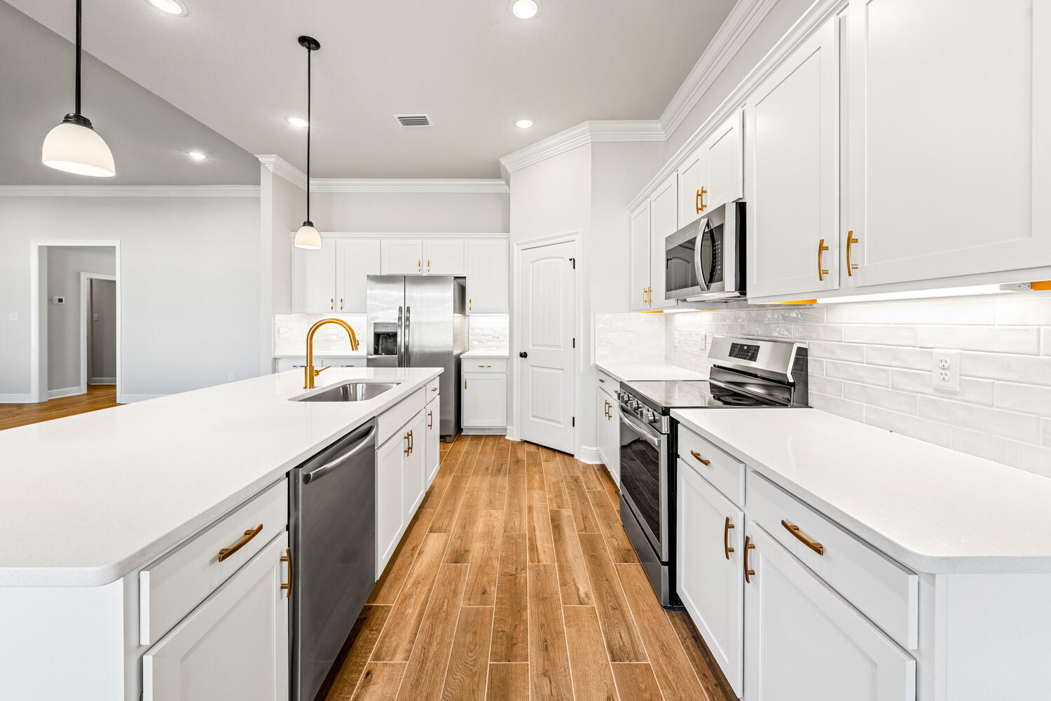 165 Splendor Run Ponce de Leon, FL 32455 - Photo 5 of 24 a large kitchen with stainless steel appliances lots of counter space and wooden floor