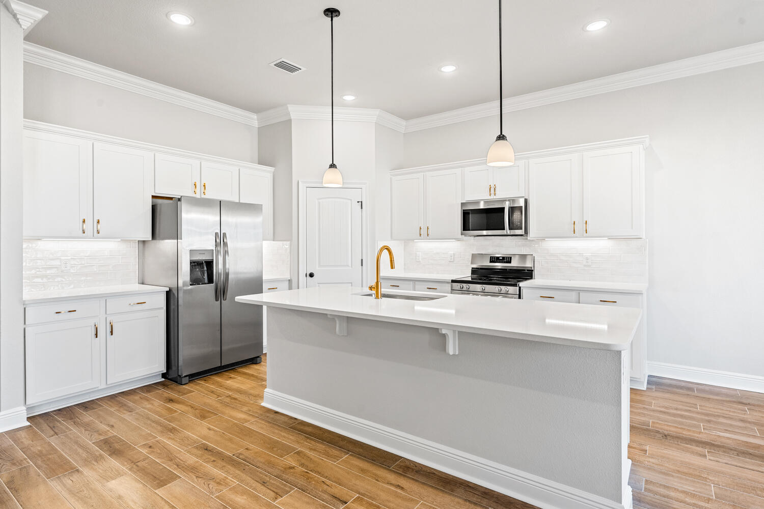 165 Splendor Run Ponce de Leon, FL 32455 - Photo 7 of 24 a kitchen with stainless steel appliances granite countertop a sink a stove a refrigerator and island with wooden floor