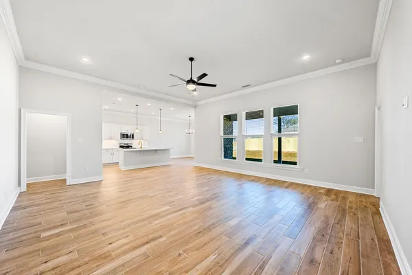 a spacious bedroom with a bed couch and a window