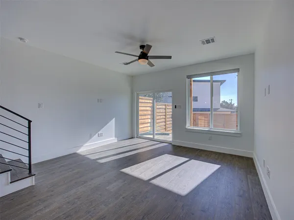 a view of an empty room and wooden floor