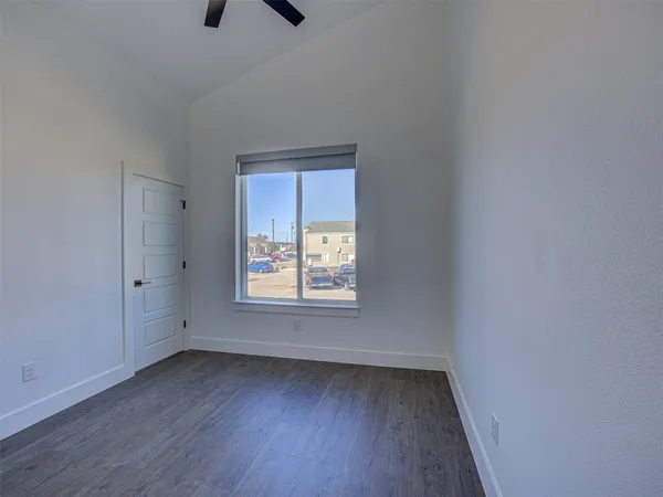 a view of an empty room with wooden floor