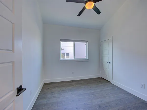 a view of hallway with wooden floor