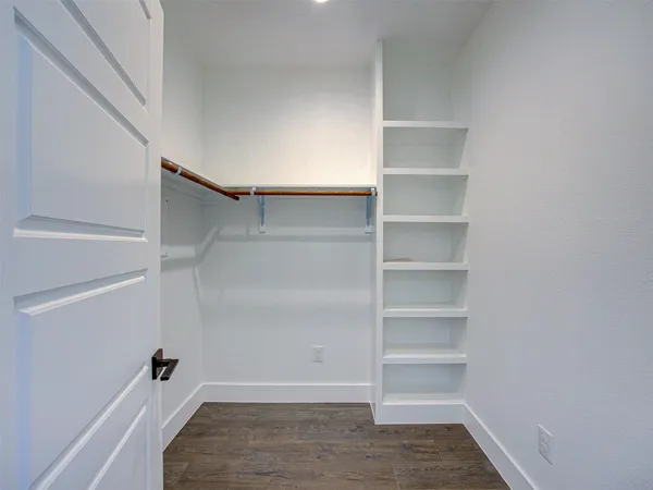 a view of a room with wooden floor and bathroom