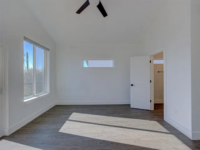 a view of a room with wooden floor and bathroom