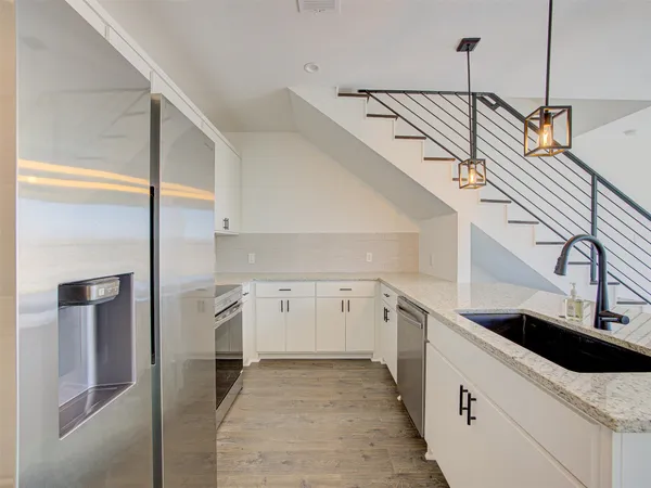 a kitchen with a sink and a mirror