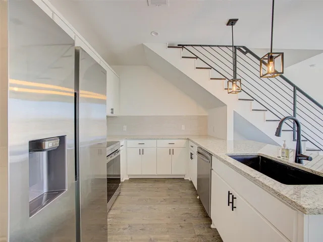 a kitchen with a sink and cabinets