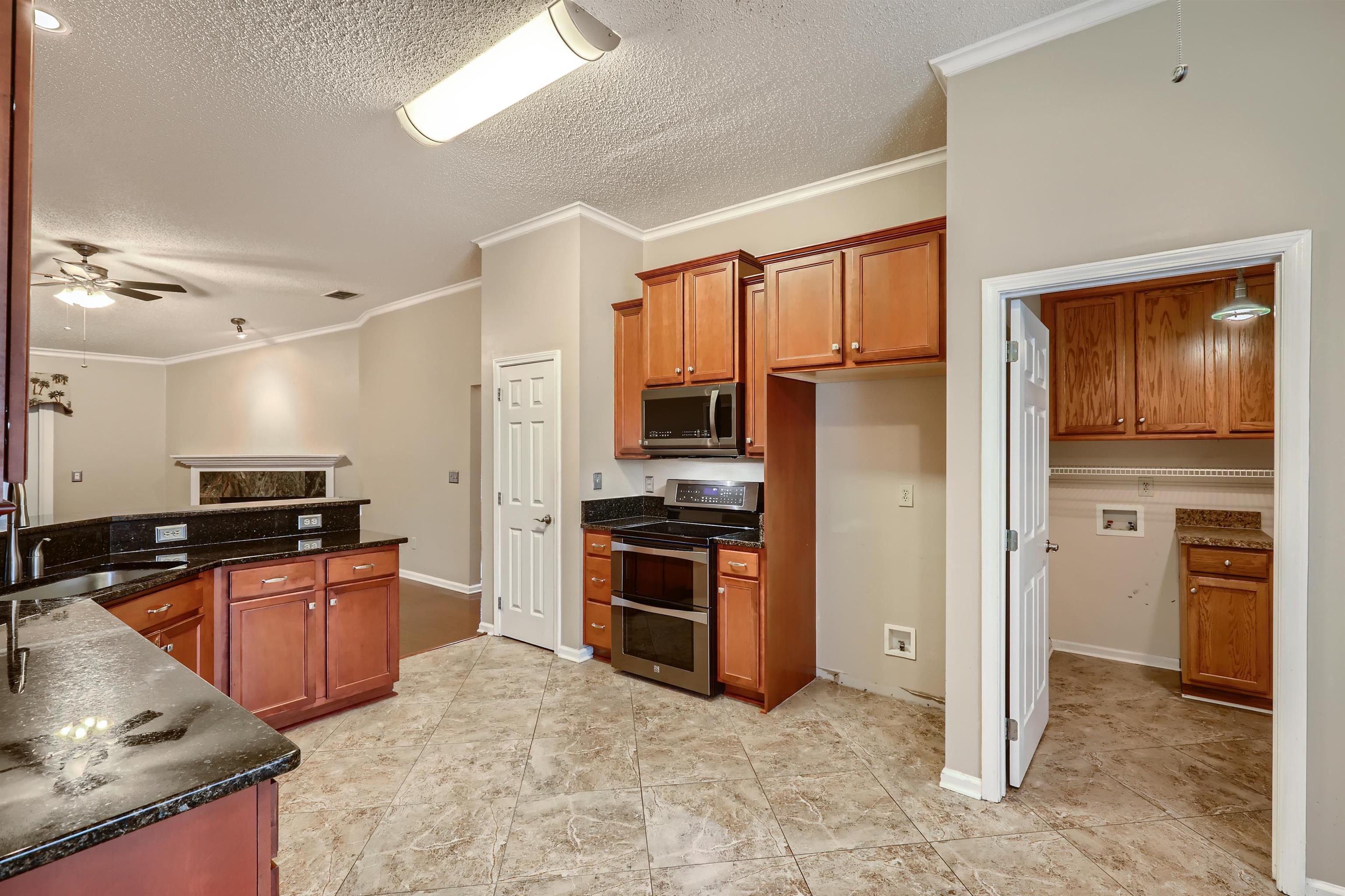 3684 Eagle Ridge Drive Jacksonville, FL 32224 - Photo 12 of 33 a kitchen with stainless steel appliances granite countertop a refrigerator stove and sink