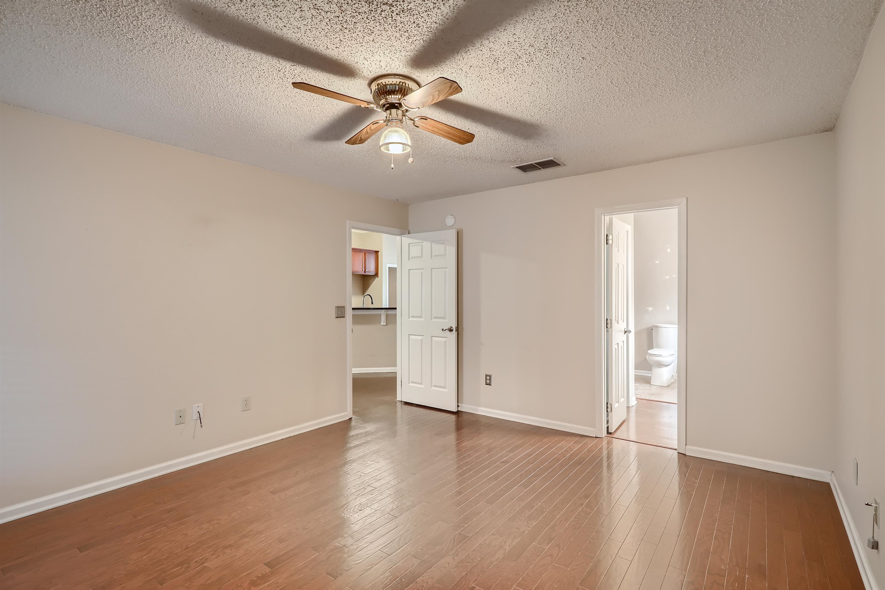 3684 Eagle Ridge Drive Jacksonville, FL 32224 - Photo 16 of 33 an empty room with wooden floor chandelier fan and windows
