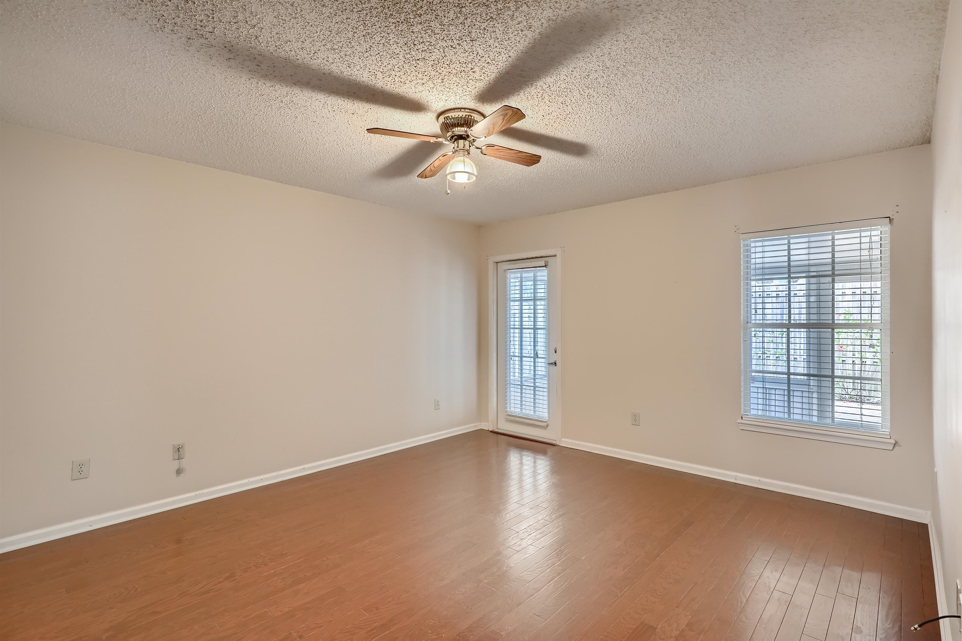 3684 Eagle Ridge Drive Jacksonville, FL 32224 - Photo 17 of 33 an empty room with wooden floor fan and windows
