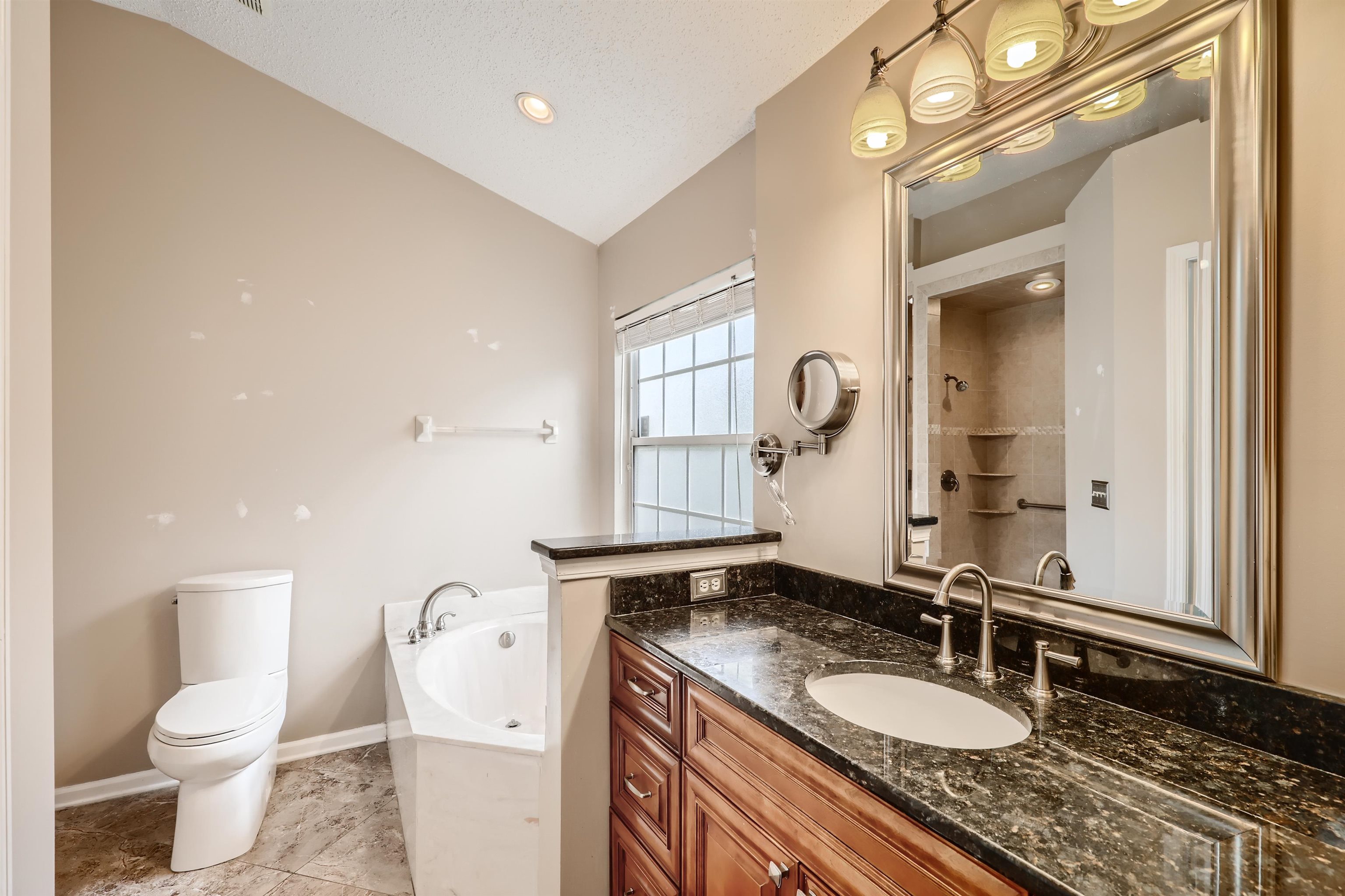 3684 Eagle Ridge Drive Jacksonville, FL 32224 - Photo 18 of 33 a bathroom with a granite countertop sink mirror vanity and toilet