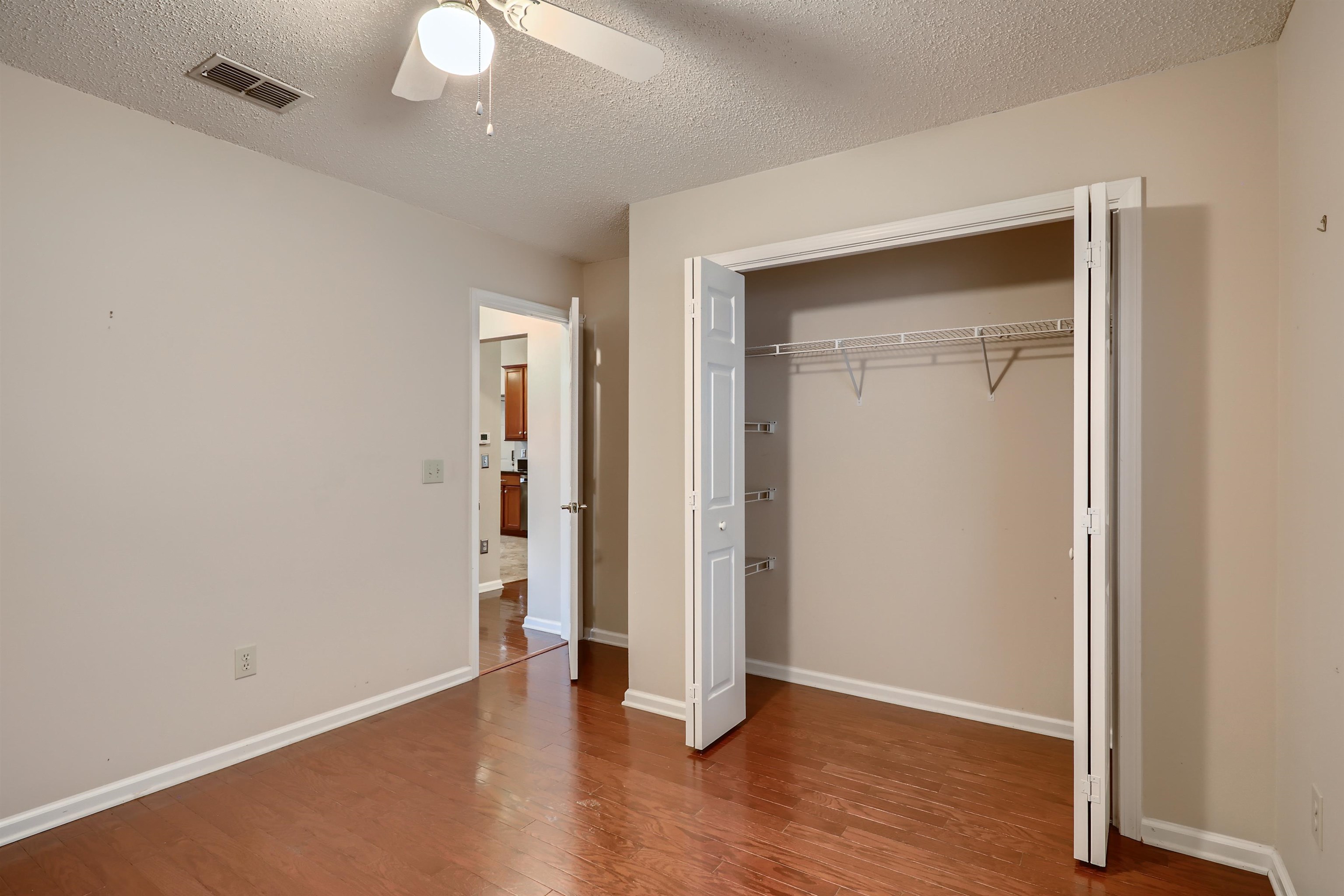 3684 Eagle Ridge Drive Jacksonville, FL 32224 - Photo 22 of 33 an empty room with wooden floor and a ceiling fan