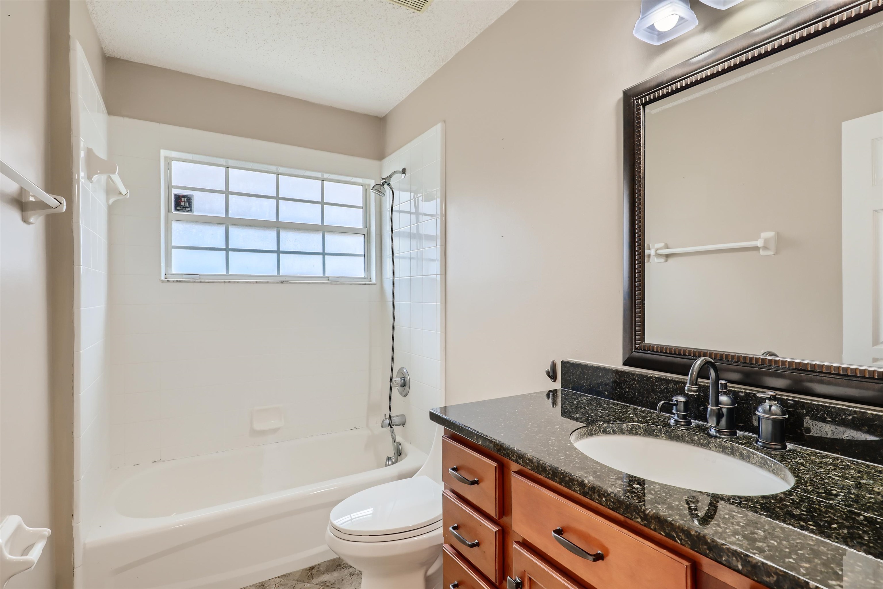 3684 Eagle Ridge Drive Jacksonville, FL 32224 - Photo 23 of 33 a bathroom with a granite countertop sink toilet mirror and shower