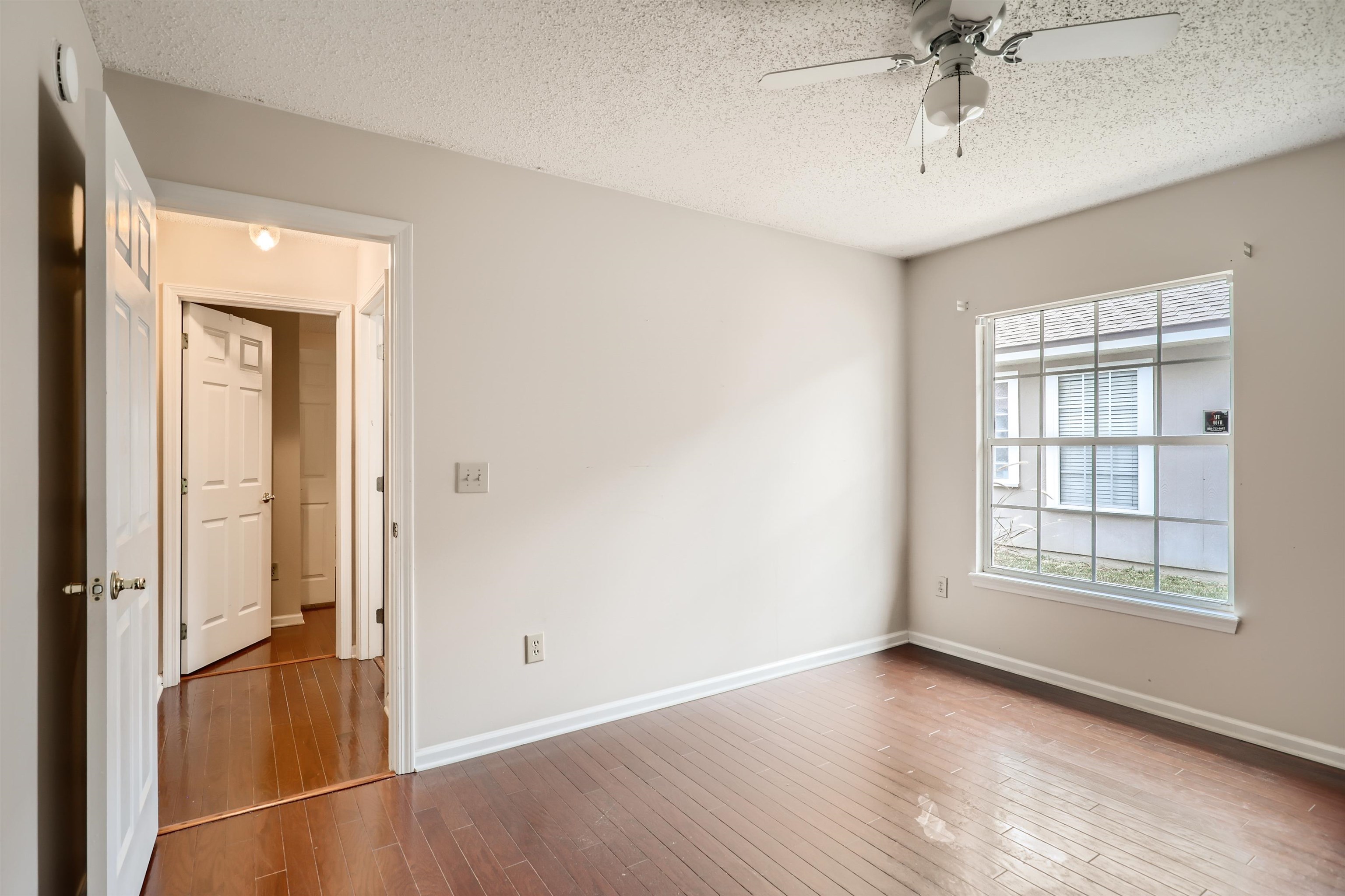 3684 Eagle Ridge Drive Jacksonville, FL 32224 - Photo 25 of 33 an empty room with wooden floor cabinet and windows