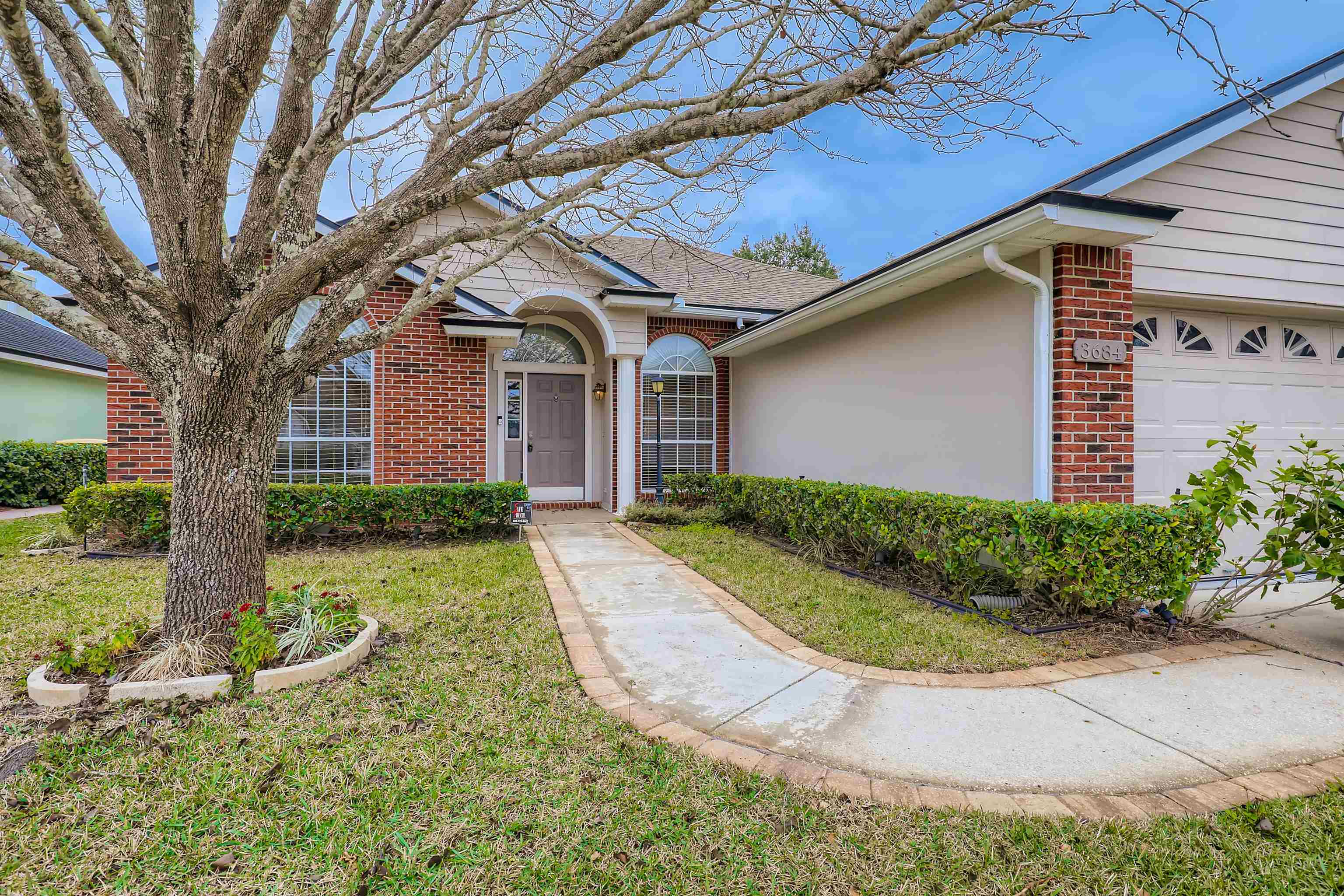 3684 Eagle Ridge Drive Jacksonville, FL 32224 - Photo 4 of 33 a front view of a house with garden