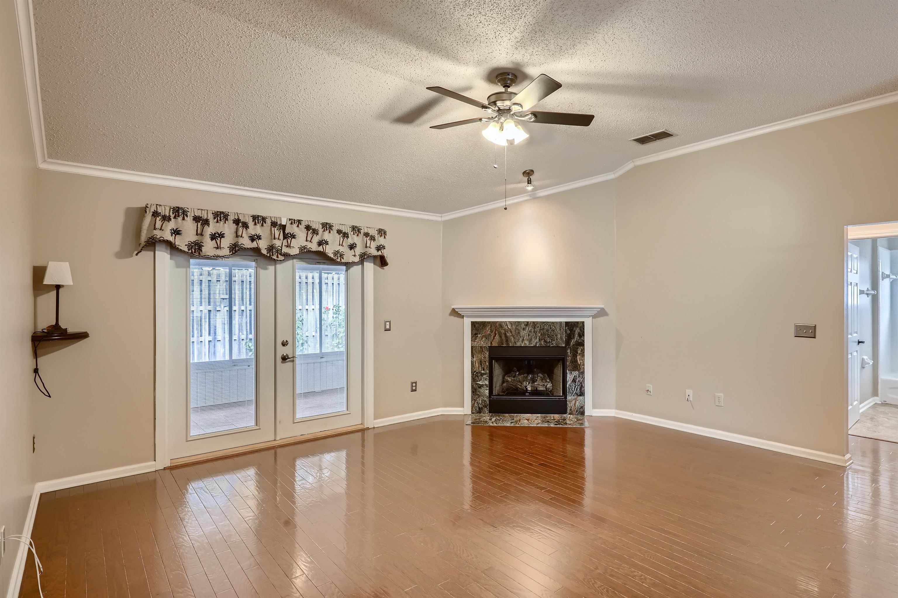 3684 Eagle Ridge Drive Jacksonville, FL 32224 - Photo 5 of 33 a view of an empty room with wooden floor and a window