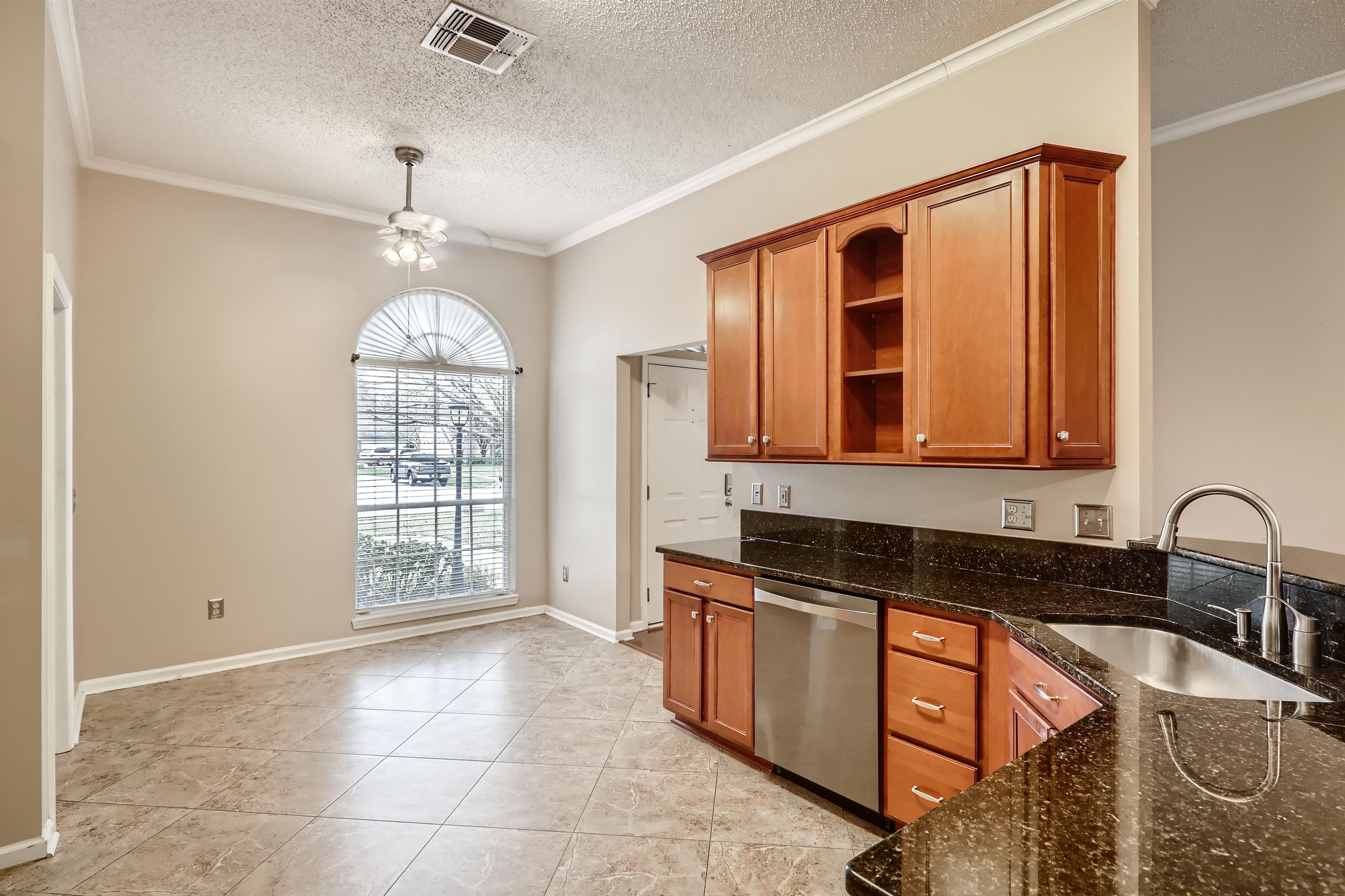 3684 Eagle Ridge Drive Jacksonville, FL 32224 - Photo 10 of 33 a kitchen with granite countertop a stove a sink and a window