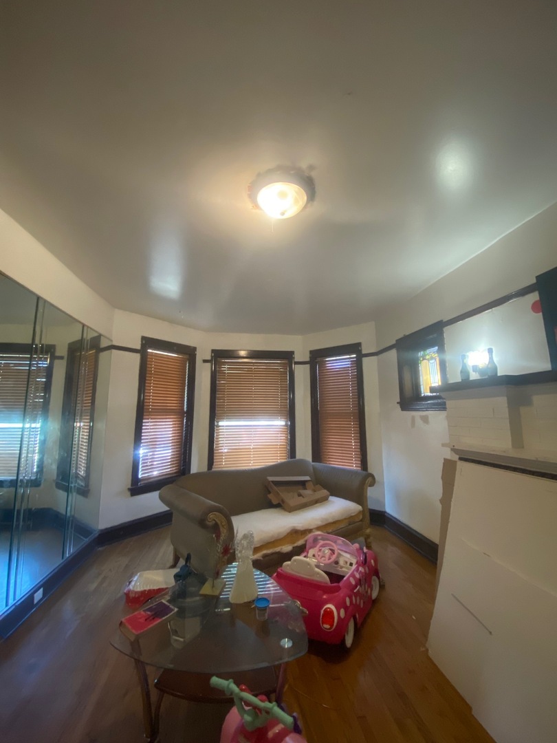 3903 West Monroe Street Chicago, IL 60624 - Photo 2 of 9 a living room with furniture and a chandelier