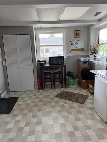 a bathroom with a granite countertop toilet sink and mirror