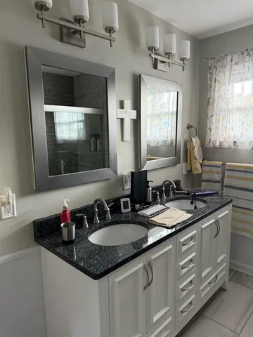 a white toilet sitting next to a white wall