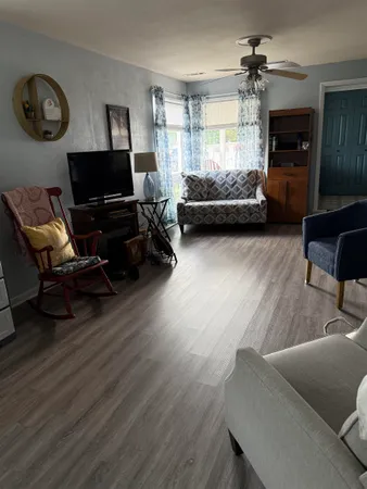 a living room with furniture and a flat screen tv