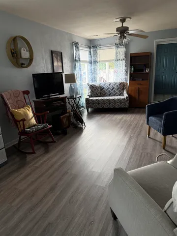 a living room with furniture and a flat screen tv