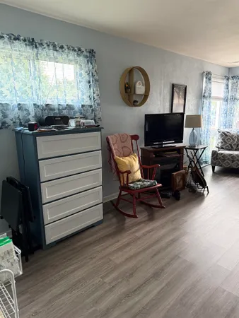 a room with wooden furniture and window