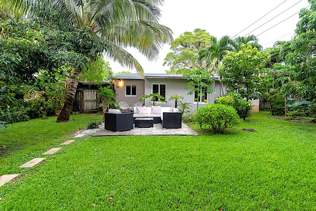 a view of a house with a backyard and a patio