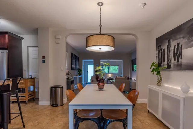 a large kitchen with a table and chairs