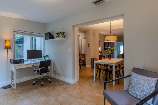 a living room with furniture a dining table and a piano table