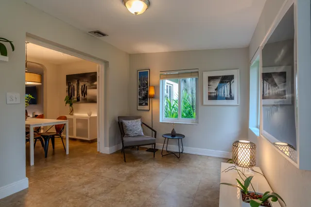a living room with furniture a dining table and a piano table