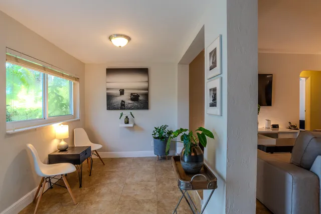 a living room with furniture and a potted plant