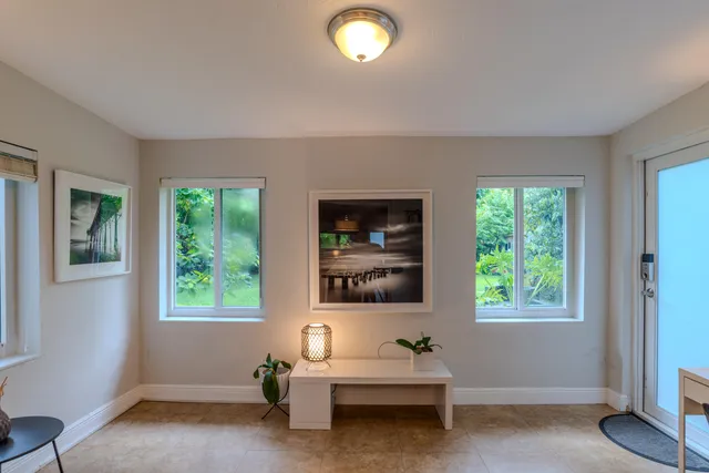 a view of a workspace with furniture and a window