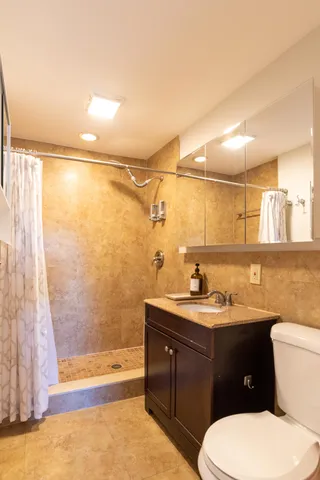 a view of a bedroom with a bed and cabinet