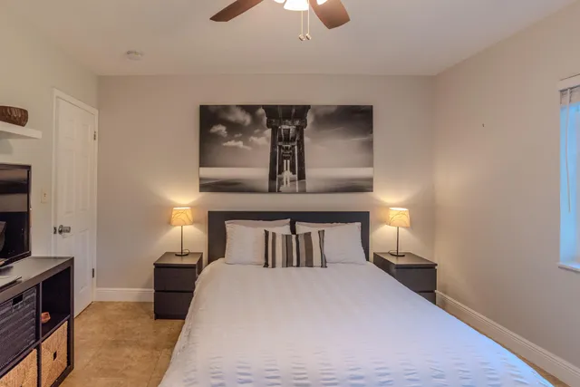 a view of a patio with table and chairs potted plants and a large tree