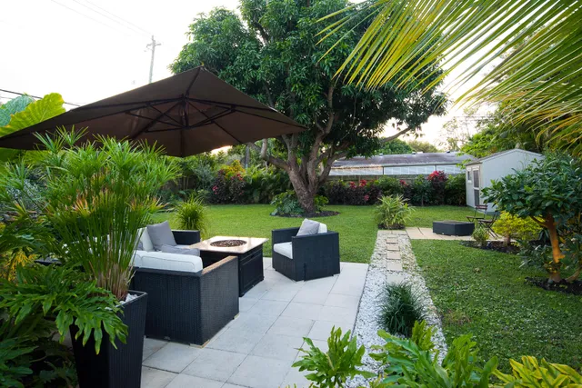 a view of a patio with table and chairs potted plants with wooden fence