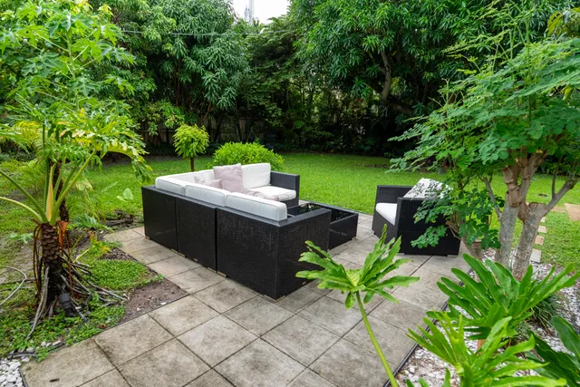 a view of a backyard with sitting area
