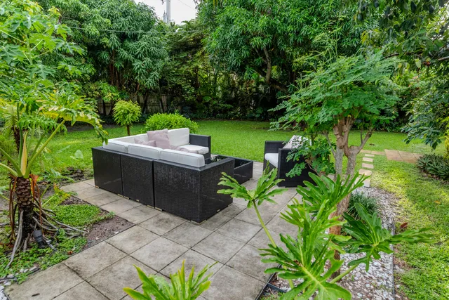 a view of a house with patio and a garden