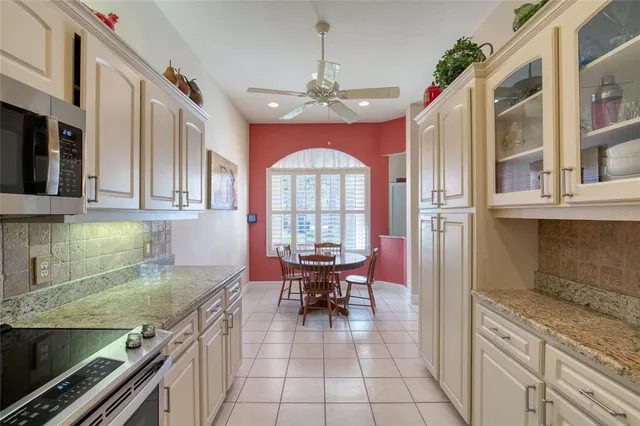 a living room with furniture a chandelier and a wooden floor